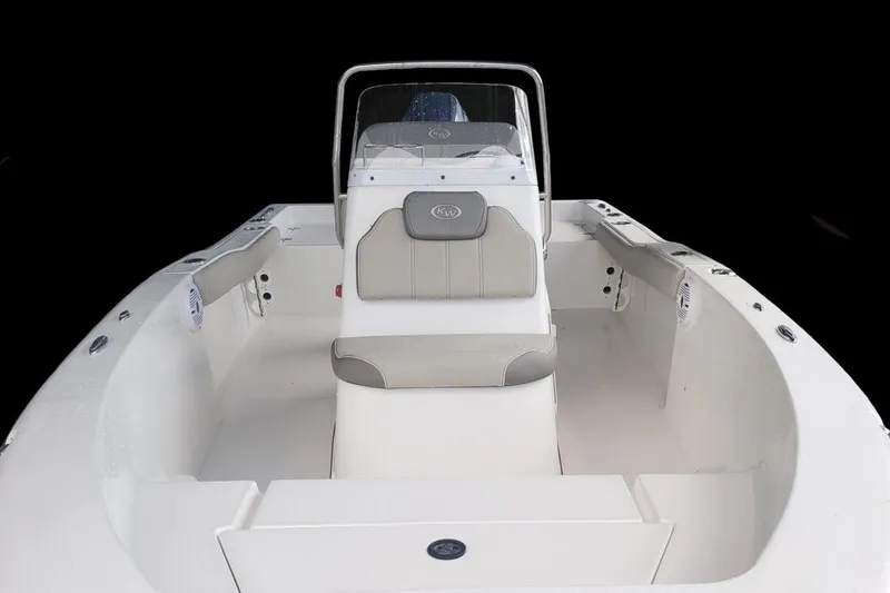 Slide: The Image of 2025 Key West 179 FS boat interior with seating and console, viewed from the stern. - 7