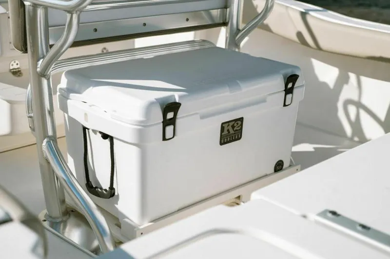 Slide: The Image of White K2 cooler on 2025 Key West 179 FS boat deck, secured with metal frame. - 8