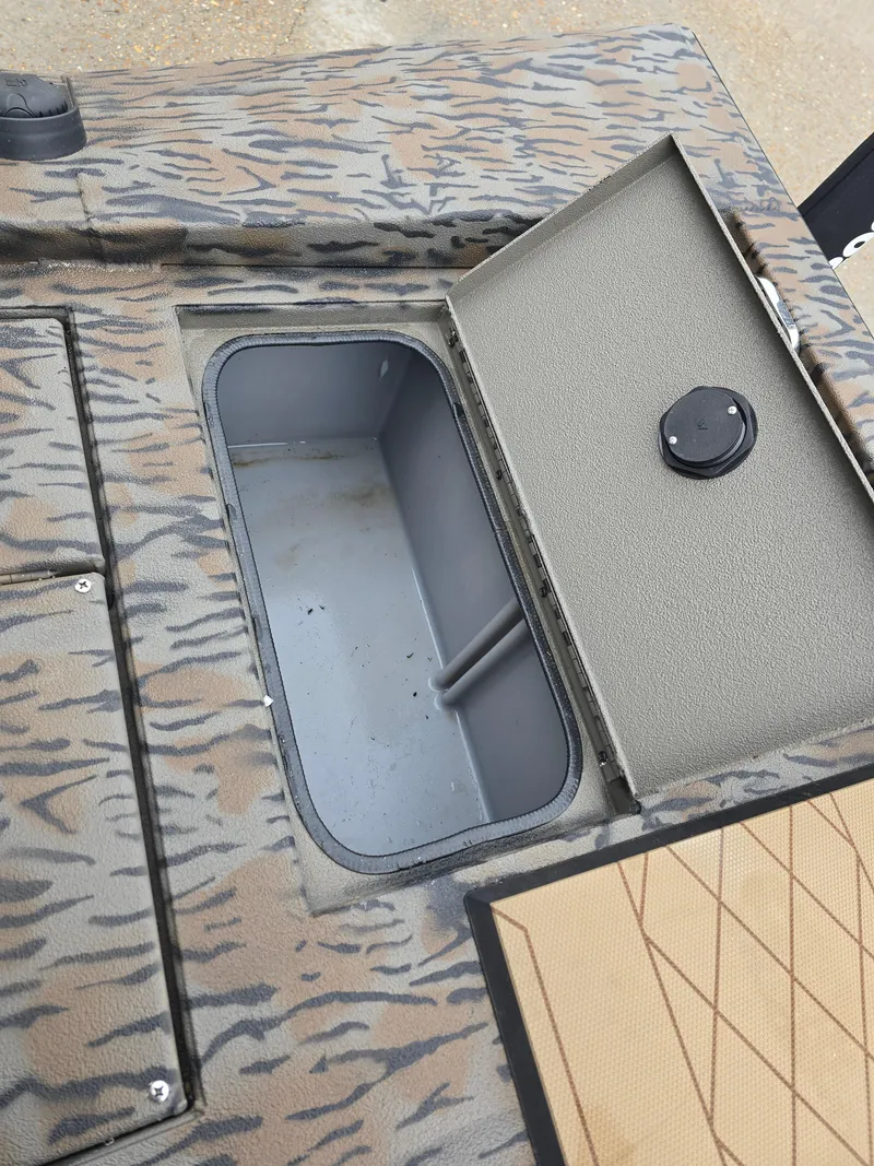 Slide: The Image of 2025 Xpress H190B boat storage compartment with open hatch, featuring camouflage design. - 10