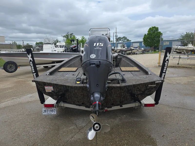 Slide: The Image of 2025 Xpress H190B boat with 115 horsepower engine, parked outdoors on a cloudy day. - 3