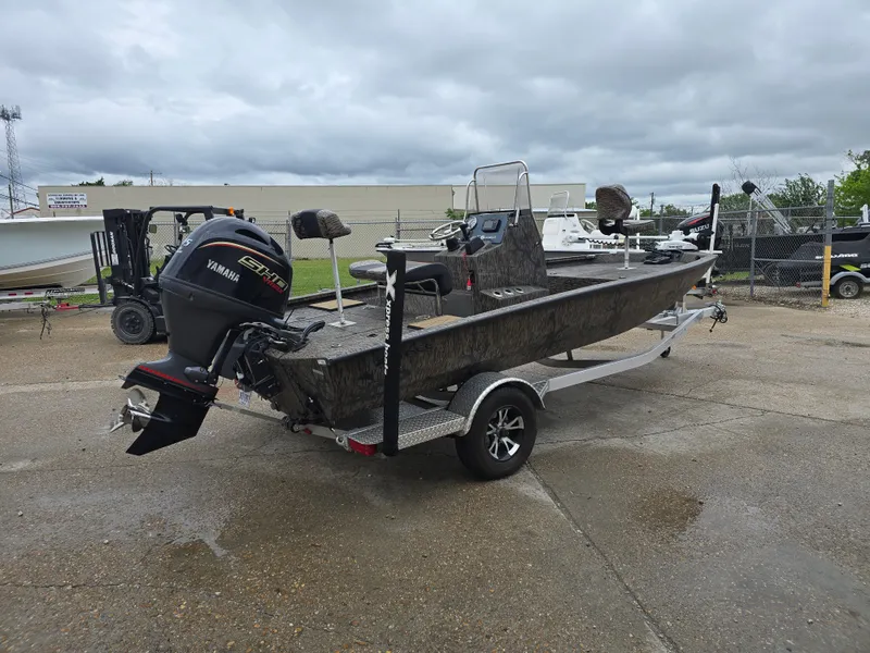 Slide: The Image of 2025 Xpress H190B boat with Yamaha engine on trailer, parked outdoors. - 4