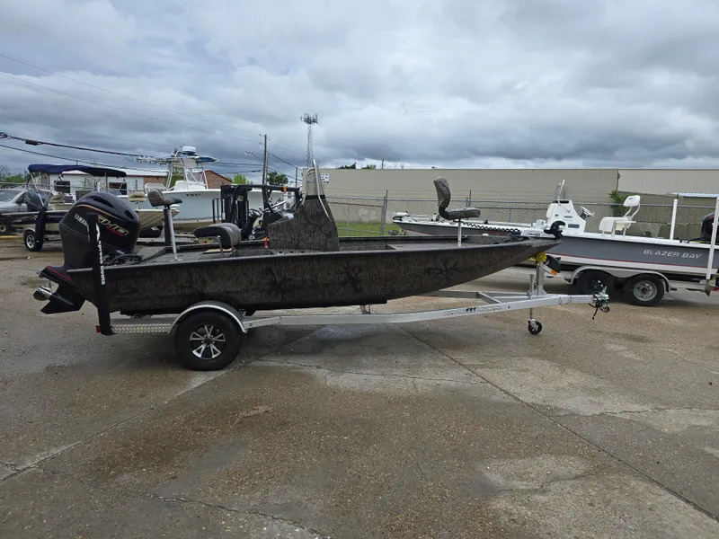 Slide: The Image of 2025 Xpress H190B boat on trailer, parked outdoors under cloudy sky. - 5
