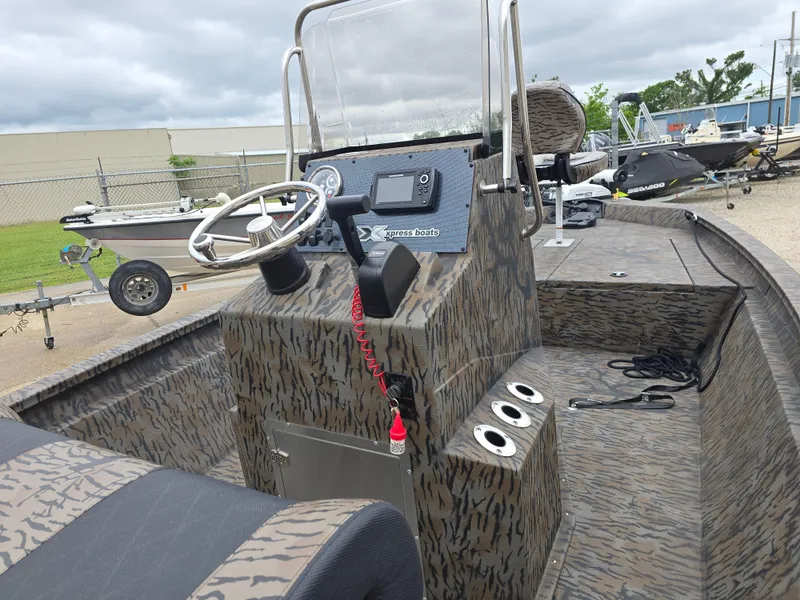 Slide: The Image of 2025 Xpress H190B boat interior with steering console, camo design, and modern controls. - 6