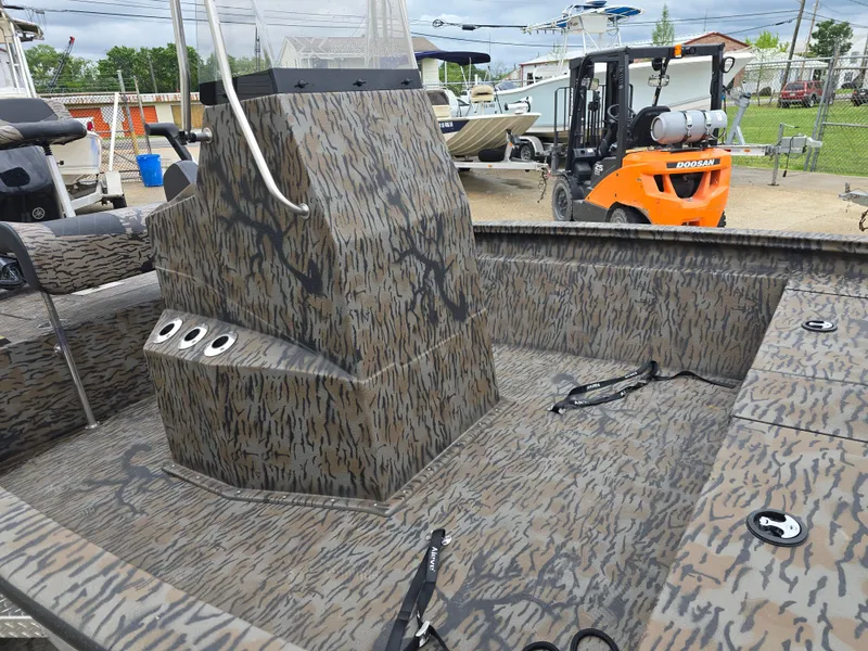 Slide: The Image of Camouflage-patterned Xpress H190B boat interior, 2025 model, with control console and seating. - 7