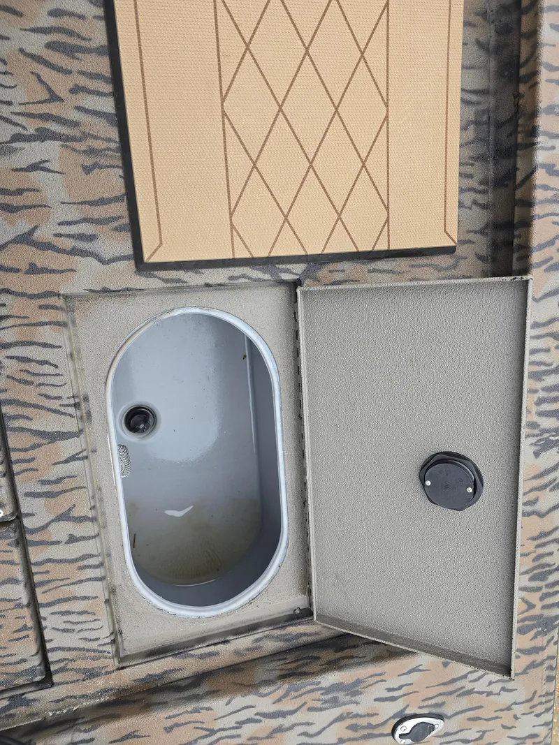 Slide: The Image of 2025 Xpress H190B boat compartment with open hatch and camouflage pattern. - 9