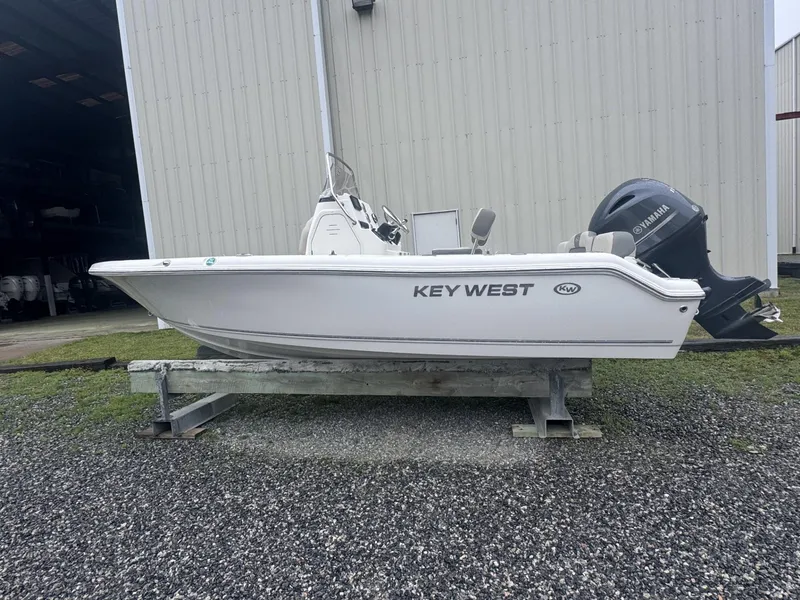Slide: The Image of 2025 Key West 189 FS boat on trailer, parked outdoors under clear blue sky. - 0