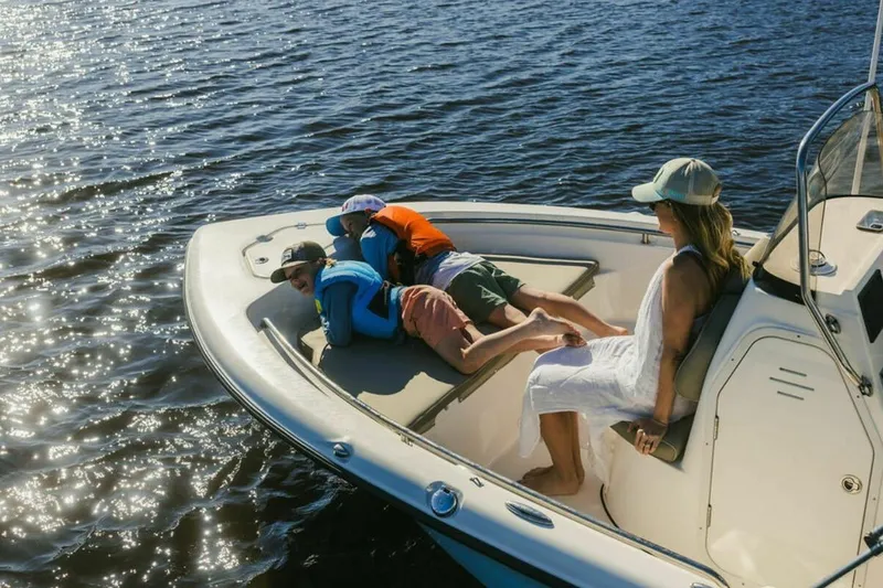 Slide: The Image of 2025 Key West 189 FS boat with Yamaha outboard motor near a large storage building. - 5