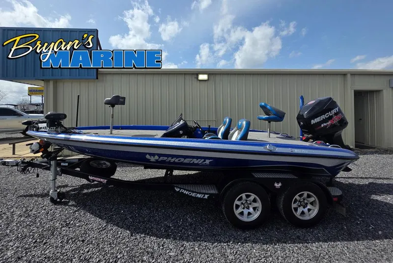 Slide: The Image of 2016 Phoenix 819 Pro boat at Bryan's Marine dealership, parked on gravel. - 1