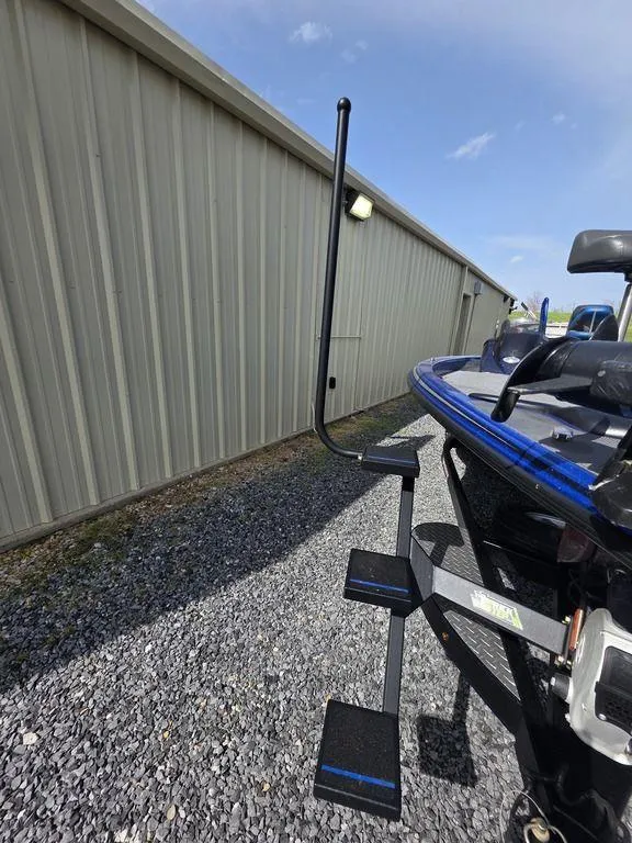 Slide: The Image of 2016 Phoenix 819 Pro boat with step ladder beside a metal building. - 14