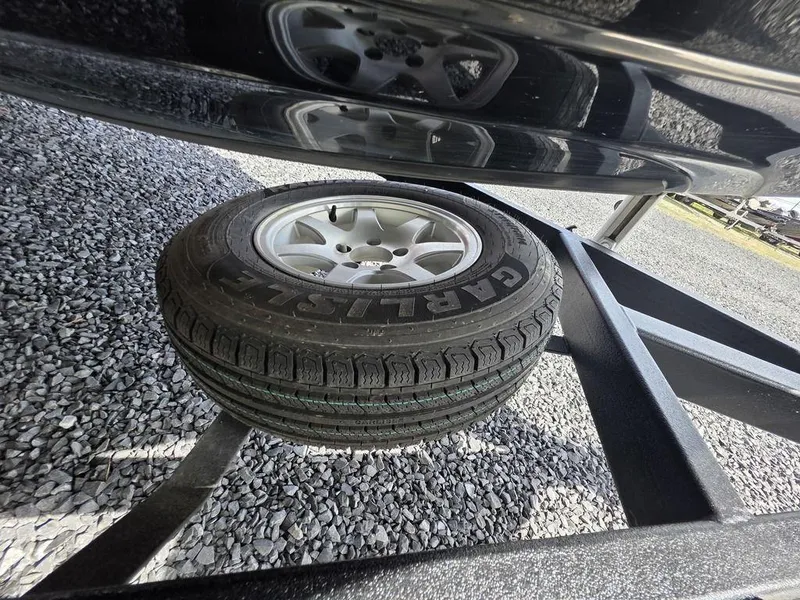 Slide: The Image of Spare tire mounted on a Phoenix 819 Pro trailer, 2016 model, on gravel surface. - 15