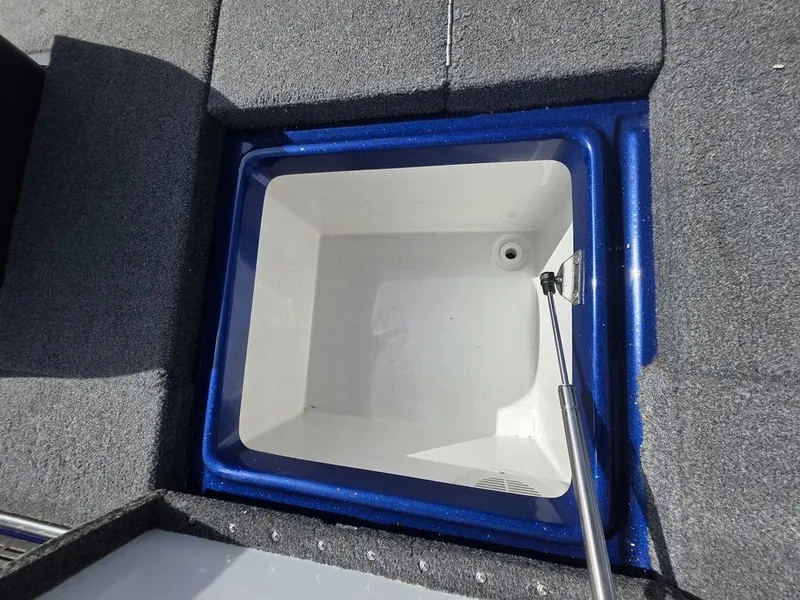 Slide: The Image of 2016 Phoenix 819 Pro boat livewell with blue trim and gray carpet. - 19