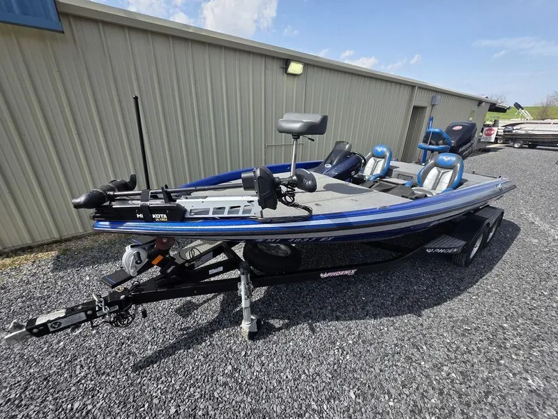 Slide: The Image of 2016 Phoenix 819 Pro fishing boat on trailer, parked beside a building. - 2