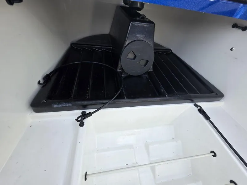 Slide: The Image of 2016 Phoenix 819 Pro boat storage compartment with black tray and cable. - 23