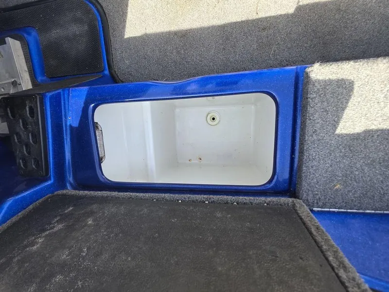 Slide: The Image of Interior storage compartment of a 2016 Phoenix 819 Pro boat, featuring blue and gray accents. - 25