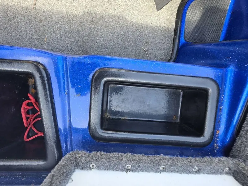 Slide: The Image of Storage compartments in a 2016 Phoenix 819 Pro boat, featuring blue and black design. - 27
