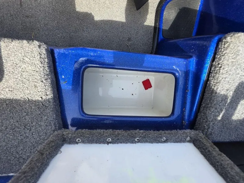 Slide: The Image of Storage compartment in a 2016 Phoenix 819 Pro boat, featuring blue and gray interior. - 28