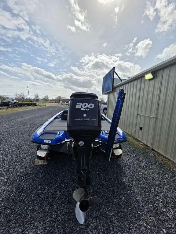 Slide: The Image of 2016 Phoenix 819 Pro boat with 200 HP engine, parked on gravel near a building. - 3