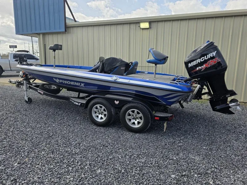 Slide: The Image of 2016 Phoenix 819 Pro boat with Mercury engine on a trailer, parked on gravel. - 30