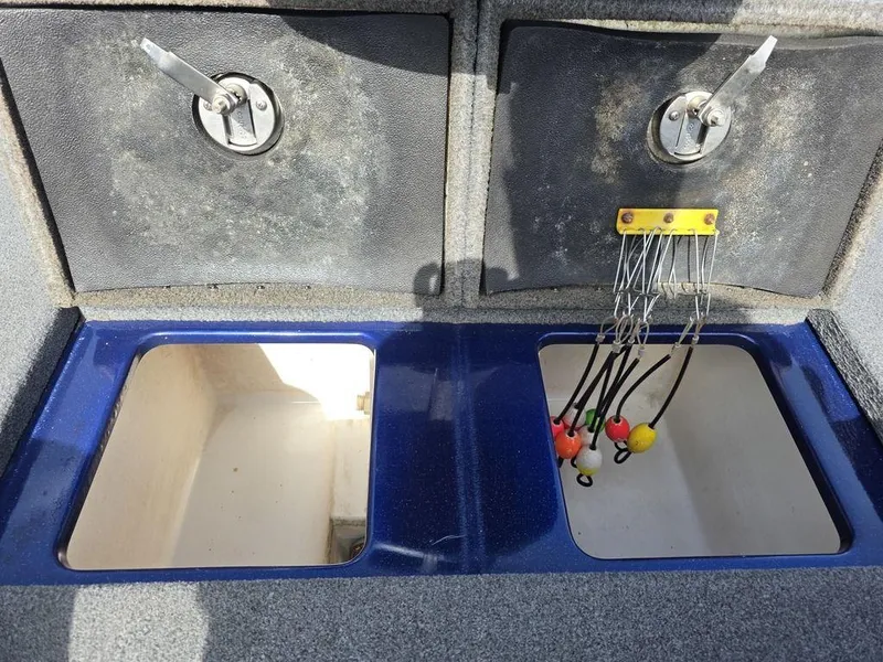 Slide: The Image of 2016 Phoenix 819 Pro boat storage compartments with fishing tackle holders. - 31