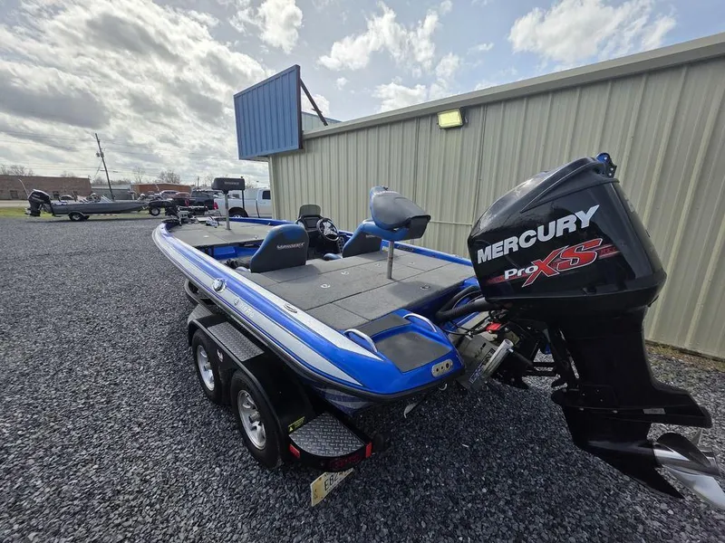 Slide: The Image of 2016 Phoenix 819 Pro boat with Mercury Pro XS engine, parked on gravel near a building. - 4