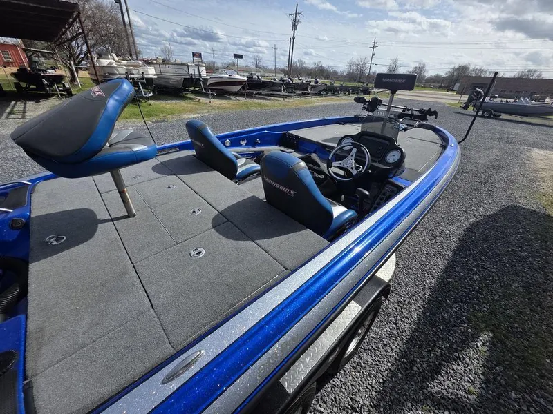 Slide: The Image of Blue 2016 Phoenix 819 Pro boat with dual seats and control panel, parked on gravel. - 5