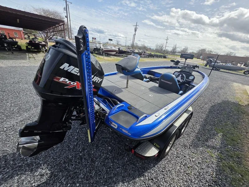 Slide: The Image of 2016 Phoenix 819 Pro boat with Mercury engine on gravel lot under cloudy sky. - 6