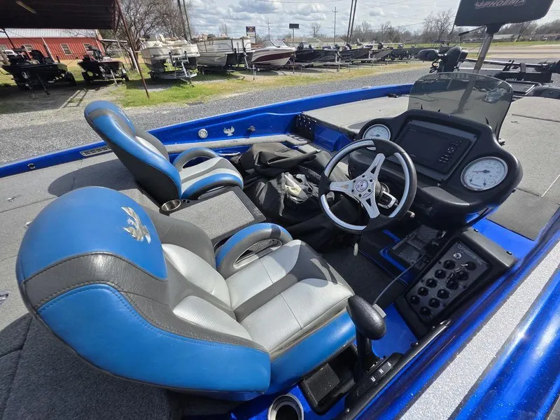 Slide: The Image of 2016 Phoenix 819 Pro boat interior with blue and gray seats, steering wheel, and dashboard controls. - 7