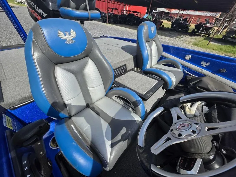 Slide: The Image of 2016 Phoenix 819 Pro boat interior with blue and gray seats and steering wheel. - 9