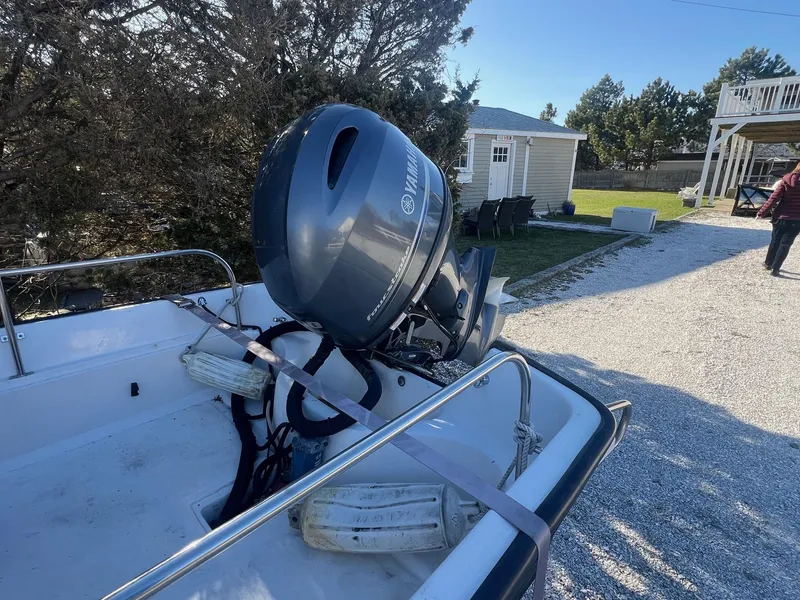 Slide: The Image of Boston Whaler 17 Montauk 2000 boat with Yamaha outboard motor in a sunny yard. - 4