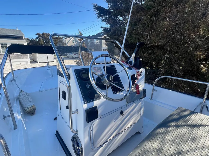 Slide: The Image of 2000 Boston Whaler 17 Montauk boat interior with steering wheel and control panel. - 5