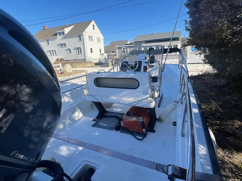 Slide: The Image of 2000 Boston Whaler 17 Montauk boat with Yamaha engine, parked outdoors. - 7
