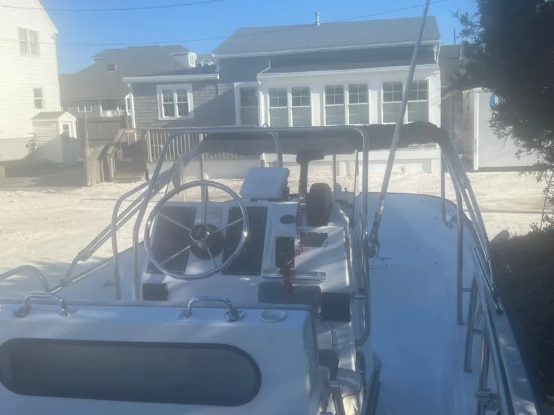 Slide: The Image of 2000 Boston Whaler 17 Montauk boat docked near residential homes. - 8