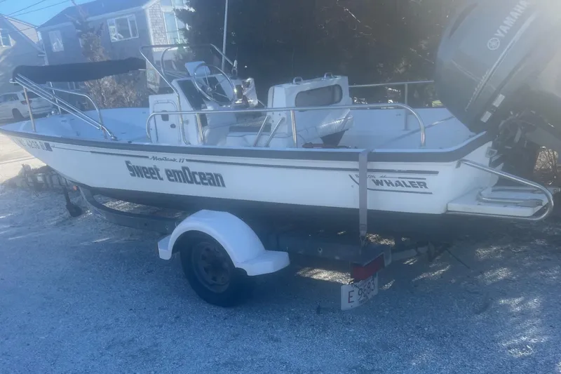 Slide: The Image of 2000 Boston Whaler 17 Montauk boat on trailer, labeled "Sweet emOcean," with Yamaha motor. - 9