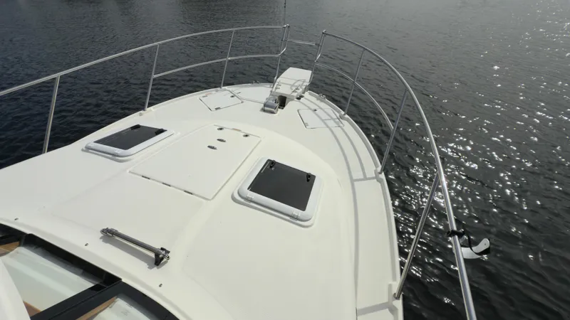 Slide: The Image of 2017 Cutwater C-302 Coupe boat deck with hatches, railing, and water view. - 11