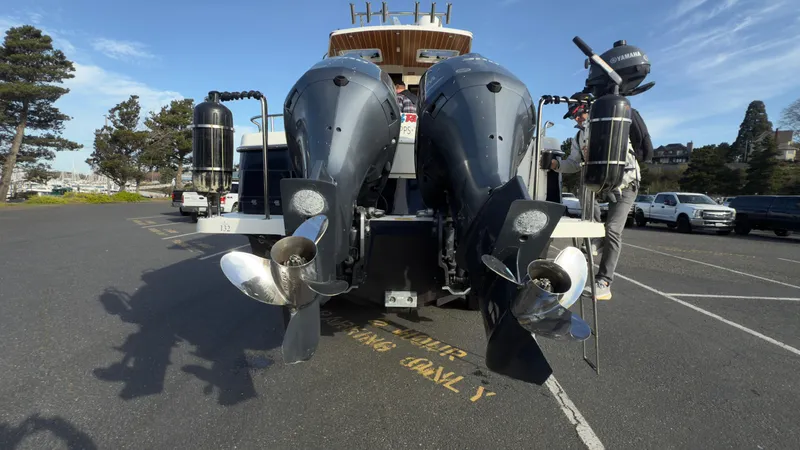 Slide: The Image of 2017 Cutwater C-302 Coupe boat with dual outboard motors in a parking lot. - 21