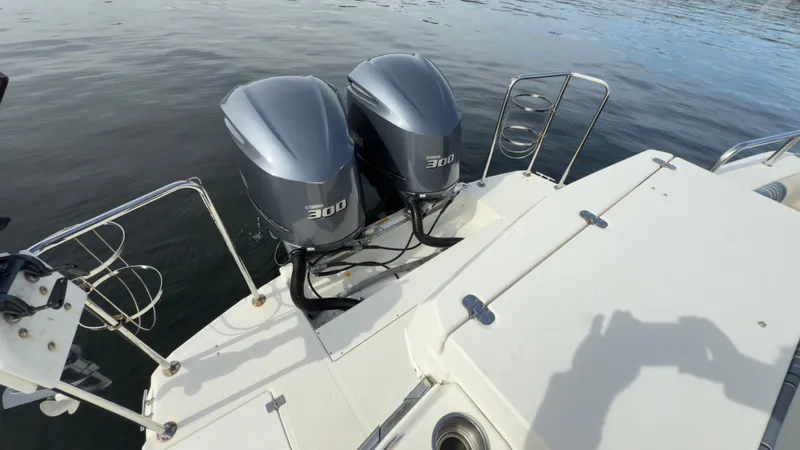 Slide: The Image of 2017 Cutwater C-302 Coupe with twin 300 horsepower outboard engines on calm water. - 22