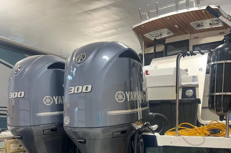 Slide: The Image of 2017 Cutwater C-302 Coupe with dual Yamaha 300 outboard engines in a garage setting. - 23