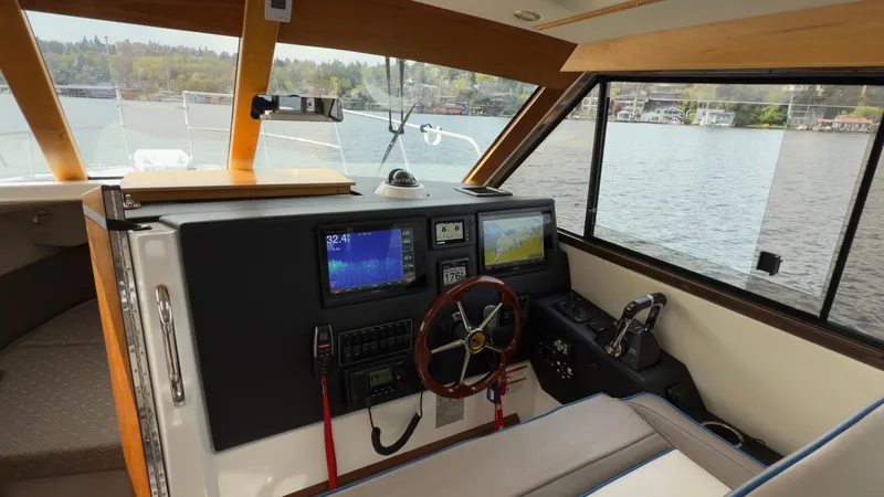 Slide: The Image of Interior view of 2017 Cutwater C-302 Coupe boat cockpit with navigation equipment. - 7