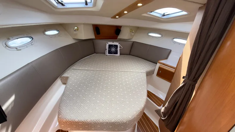 Slide: The Image of 2017 Cutwater C-302 Coupe interior cabin with cozy bed and portholes. - 8