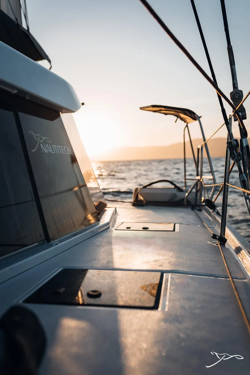 Slide: The Image of 2025 Nautitech 44 Open sailing at sunset, ocean view from deck. - 17