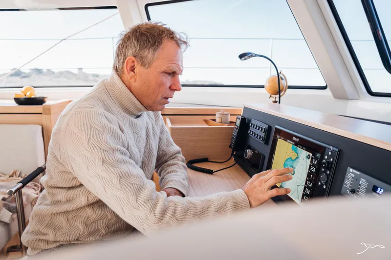 Slide: The Image of Man navigating on Nautitech 44 Open yacht, 2025 model, using touchscreen controls. - 32