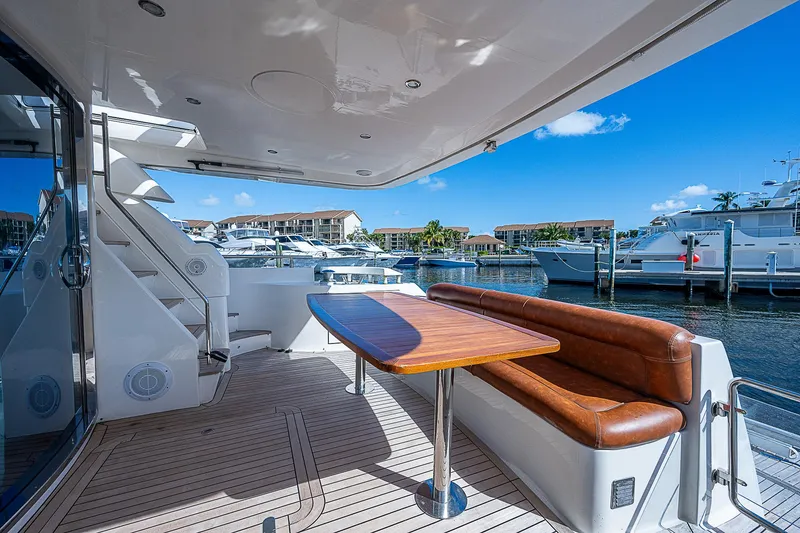 Slide: The Image of Luxurious 2009 Aicon 64 yacht deck with seating, table, and marina view. - 7