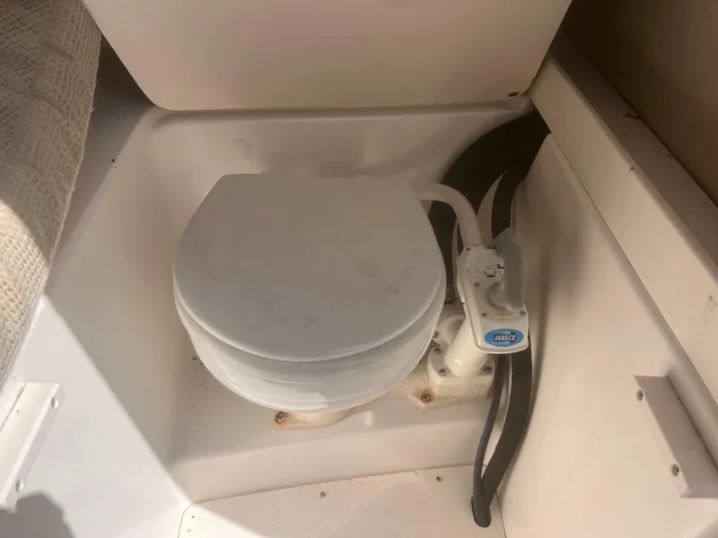 Slide: The Image of 2004 Robalo R225 Walkaround boat toilet in cabin area. - 22