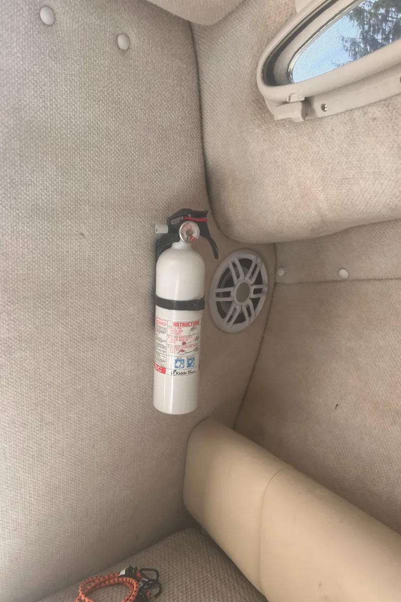 Slide: The Image of 2004 Robalo R225 Walkaround cabin interior with fire extinguisher and speaker. - 23