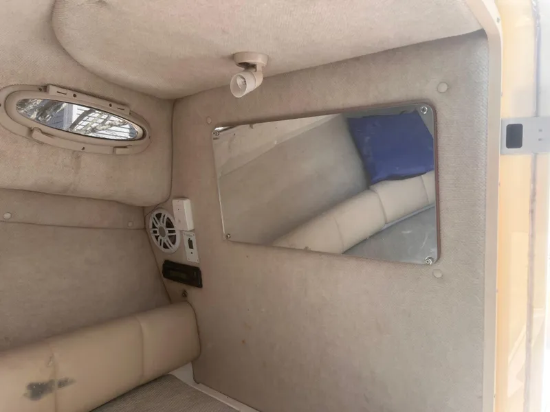 Slide: The Image of 2004 Robalo R225 Walkaround cabin interior with mirror and speaker. - 24