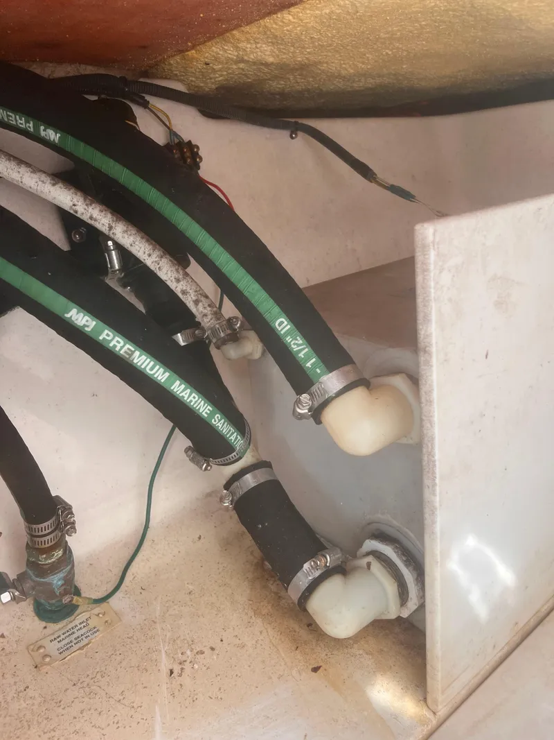 Slide: The Image of 2004 Robalo R225 Walkaround boat plumbing system with marine hoses and fittings. - 28