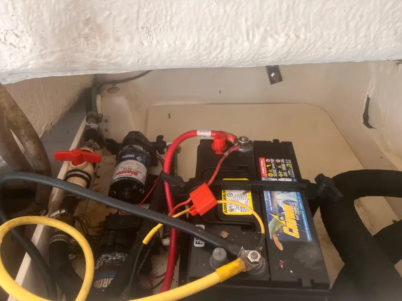 Slide: The Image of Battery compartment of a 2004 Robalo R225 Walkaround boat with wiring and components. - 31