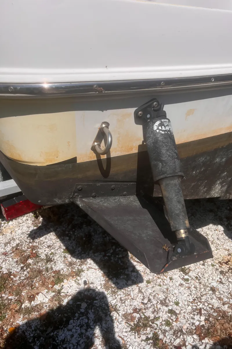 Slide: The Image of 2004 Robalo R225 Walkaround boat stern with trim tab and zinc anode. - 32