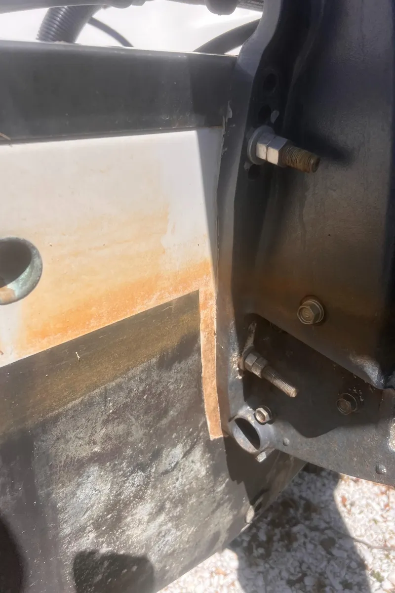 Slide: The Image of Close-up of a 2004 Robalo R225 Walkaround boat engine with visible rust. - 33