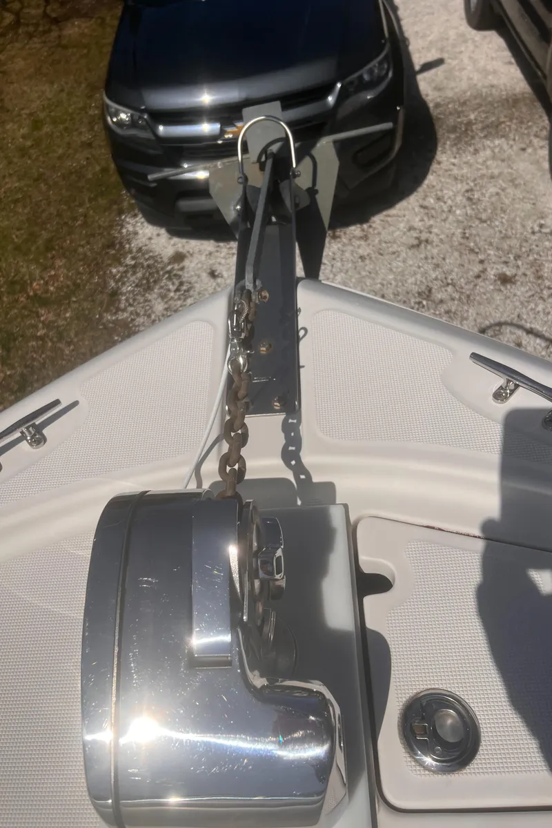 Slide: The Image of 2004 Robalo R225 Walkaround boat hitched to a vehicle, ready for transport. - 35